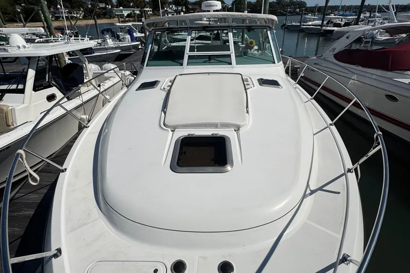 Slide: The Image of 2000 Tiara Yachts 3500 Express docked at marina, showcasing sleek deck design. - 18