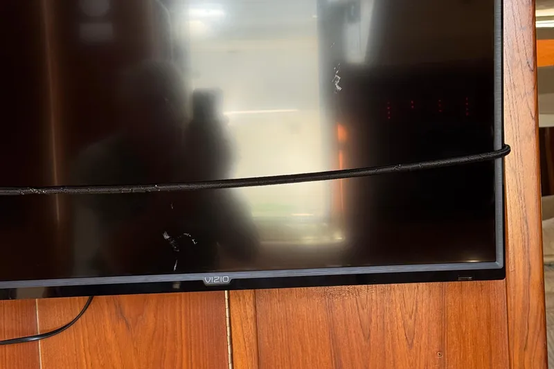 Slide: The Image of Vizio TV mounted on wooden panel inside 2000 Tiara Yachts 3500 Express. - 37