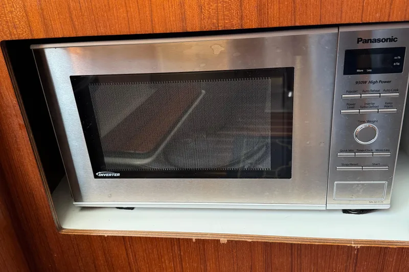 Slide: The Image of Panasonic microwave in 2000 Tiara Yachts 3500 Express, wood paneling background. - 38