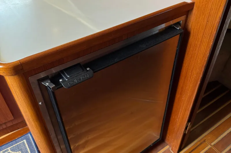 Slide: The Image of Wood-paneled interior of 2000 Tiara Yachts 3500 Express with built-in fridge. - 39