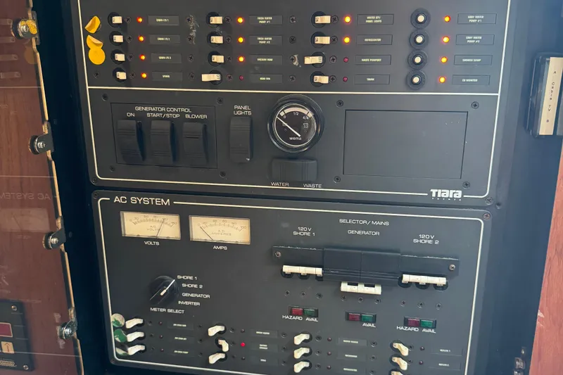 Slide: The Image of Control panel of a 2000 Tiara Yachts 3500 Express, featuring generator and AC system controls. - 41