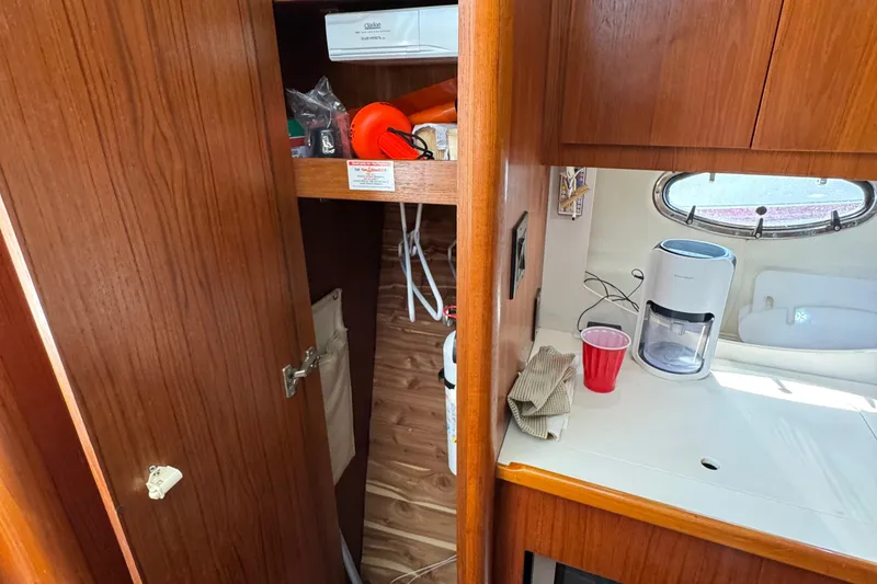 Slide: The Image of Interior of 2000 Tiara Yachts 3500 Express with wooden cabinetry and countertop. - 42