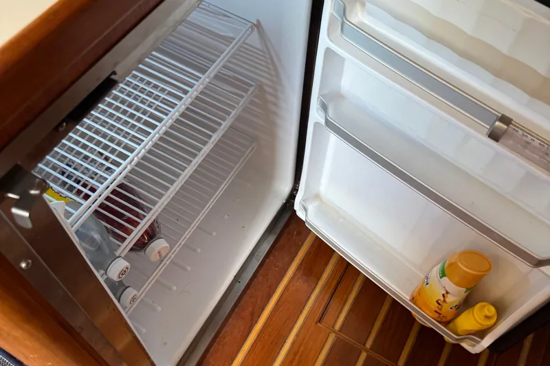 Slide: The Image of Open fridge on 2000 Tiara Yachts 3500 Express with drinks and condiments inside. - 43