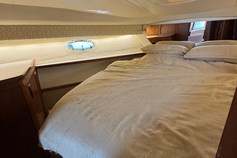 Slide: The Image of Cozy cabin interior of 2000 Tiara Yachts 3500 Express with bed and porthole. - 44