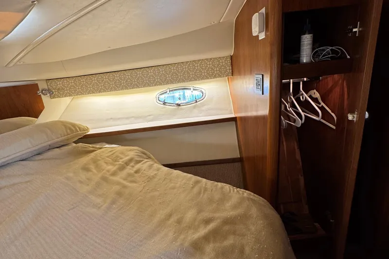 Slide: The Image of Interior cabin of 2000 Tiara Yachts 3500 Express with bed, porthole, and closet. - 45