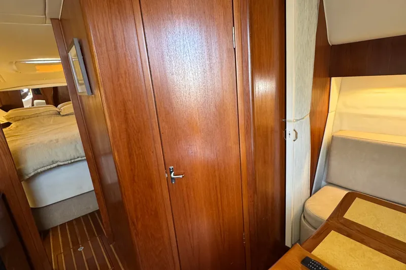 Slide: The Image of Interior of 2000 Tiara Yachts 3500 Express with wood paneling and cozy seating area. - 47