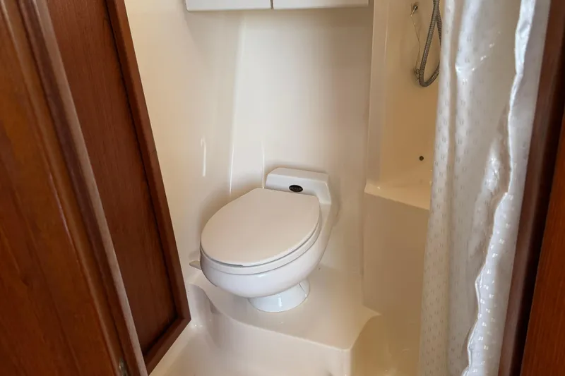 Slide: The Image of Bathroom interior of 2000 Tiara Yachts 3500 Express with toilet and shower. - 48