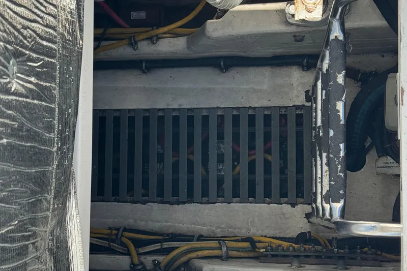 Slide: The Image of Engine compartment of a 2000 Tiara Yachts 3500 Express with visible wiring and components. - 53
