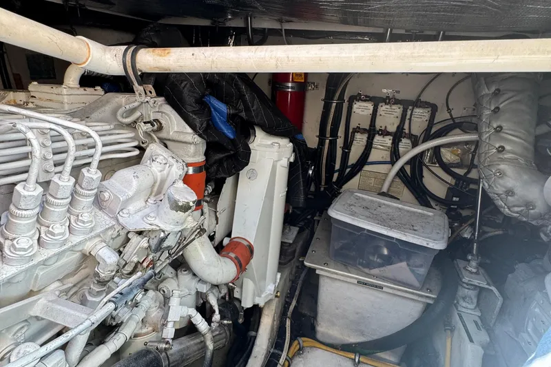 Slide: The Image of Engine room of a 2000 Tiara Yachts 3500 Express, showcasing mechanical components and wiring. - 58