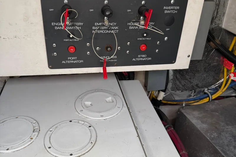 Slide: The Image of Control panel of a 2000 Tiara Yachts 3500 Express, featuring battery switches and alternator controls. - 61