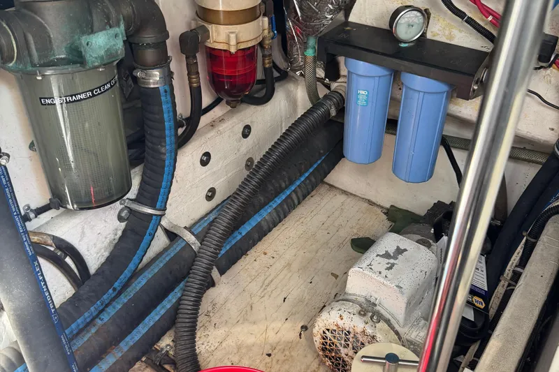Slide: The Image of Engine compartment of a 2000 Tiara Yachts 3500 Express with filters and hoses visible. - 62
