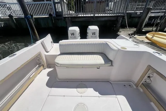 Slide: The Image of 1996 Grady-White Voyager 248 boat interior with seating and twin V6 engines. - 12