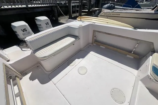 Slide: The Image of 1996 Grady-White Voyager 248 boat deck with seating and twin V6 engines. - 14