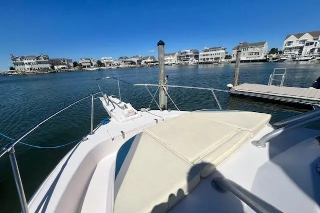 Slide: The Image of 1996 Grady-White Voyager 248 boat docked in a scenic waterfront area. - 15
