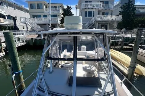 Slide: The Image of 1996 Grady-White Voyager 248 boat docked near waterfront homes. - 16