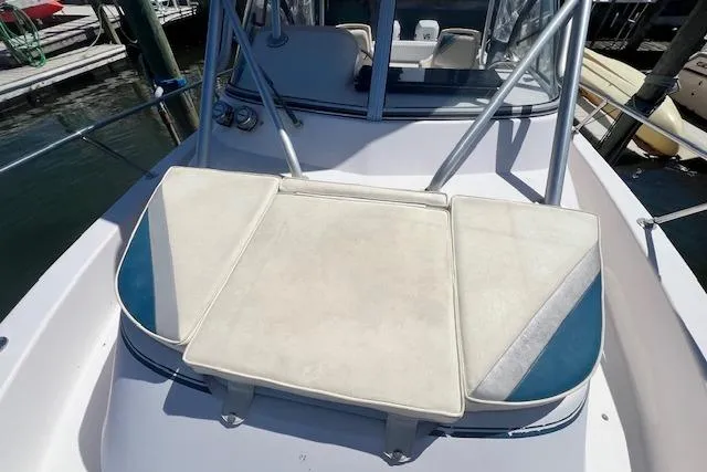 Slide: The Image of 1996 Grady-White Voyager 248 boat with cushioned seating on deck. - 17