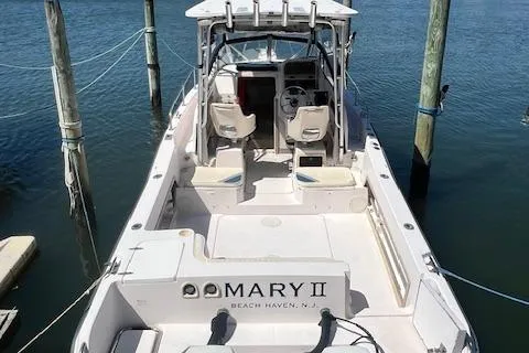 Slide: The Image of 1996 Grady-White Voyager 248 boat docked in marina, rear view. - 2