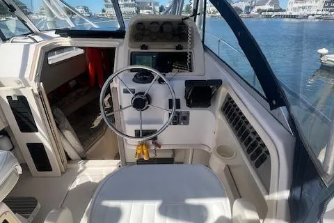 Slide: The Image of 1996 Grady-White Voyager 248 boat cockpit with steering wheel and control panel. - 3