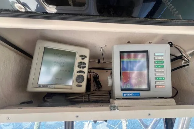 Slide: The Image of Navigation equipment on a 1996 Grady-White Voyager 248 boat dashboard. - 5