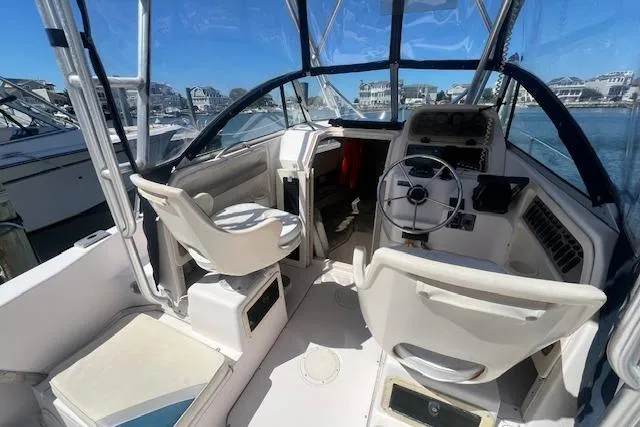 Slide: The Image of 1996 Grady-White Voyager 248 boat interior with steering wheel and seating. - 6