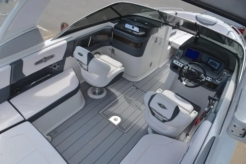 Slide: The Image of 2020 Chaparral 25 Surf boat interior with modern seating and advanced dashboard controls. - 21