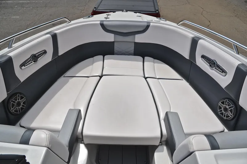 Slide: The Image of 2020 Chaparral 25 Surf boat interior with white and gray seating. - 23