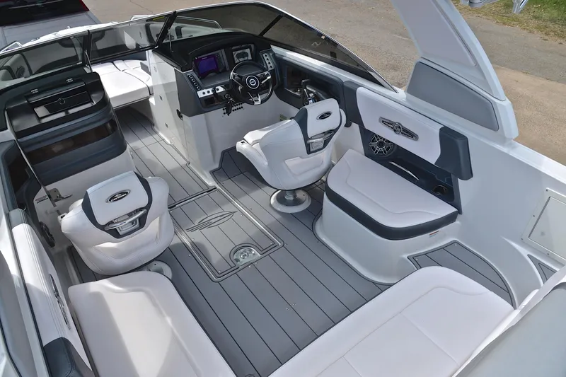 Slide: The Image of 2020 Chaparral 25 Surf boat interior with modern seating and sleek dashboard design. - 26