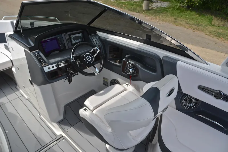 Slide: The Image of 2020 Chaparral 25 Surf boat cockpit with modern steering and control panel. - 27