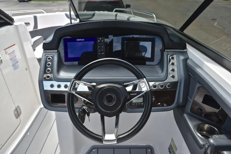 Slide: The Image of 2020 Chaparral 25 Surf boat dashboard with steering wheel and digital displays. - 28