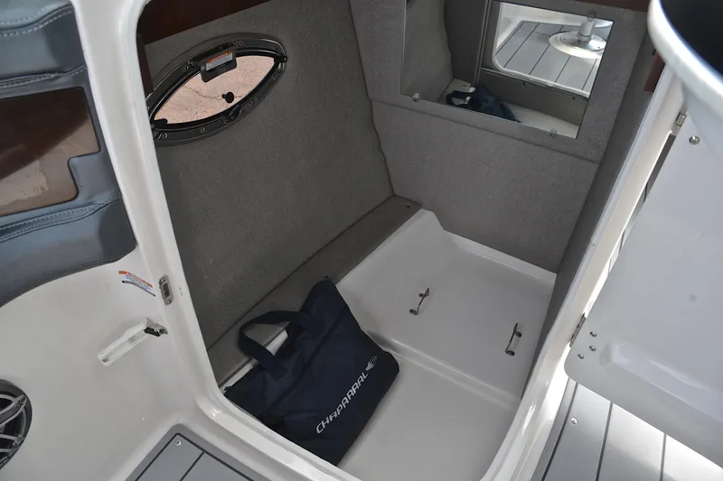 Slide: The Image of 2020 Chaparral 25 Surf boat interior with storage area and Chaparral branded bag. - 29