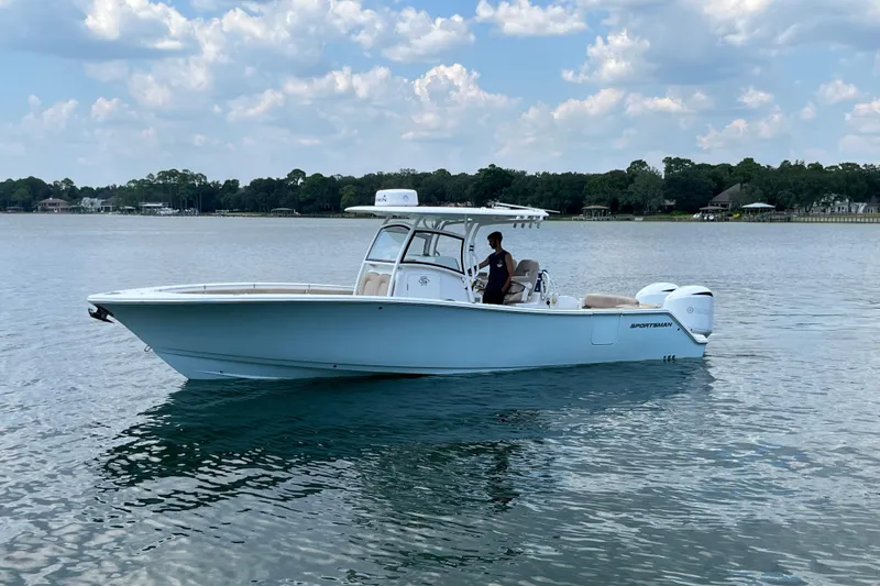 Slide: The Image of 2020 Sportsman Open 312 Center Console boat on calm water under a cloudy sky. - 0