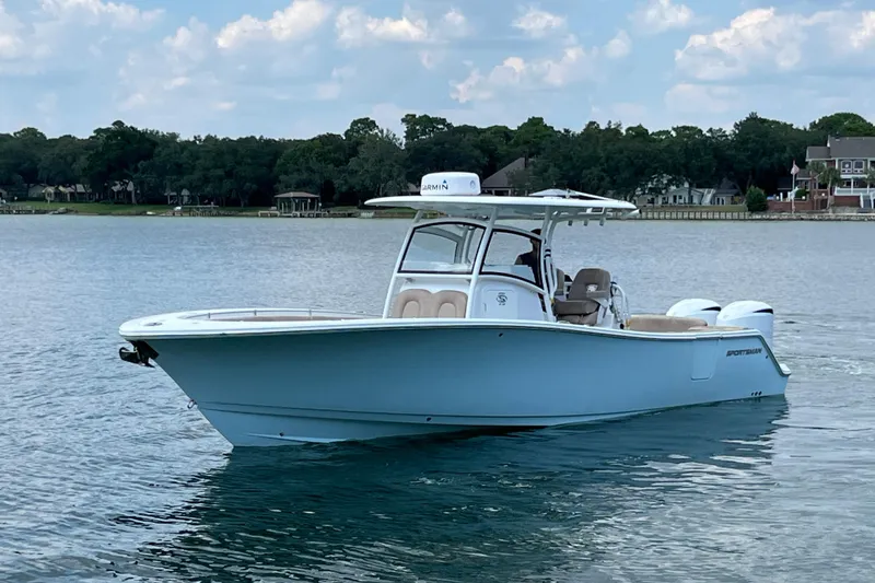 Slide: The Image of 2020 Sportsman Open 312 Center Console boat on a calm lake. - 1