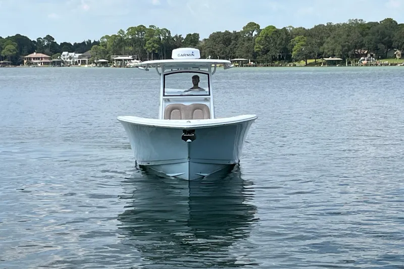 Slide: The Image of 2020 Sportsman Open 312 Center Console boat on calm lake waters. - 10