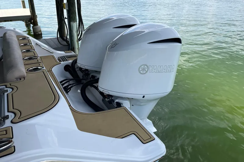 Slide: The Image of 2020 Sportsman Open 312 Center Console with twin Yamaha outboard motors on water. - 11