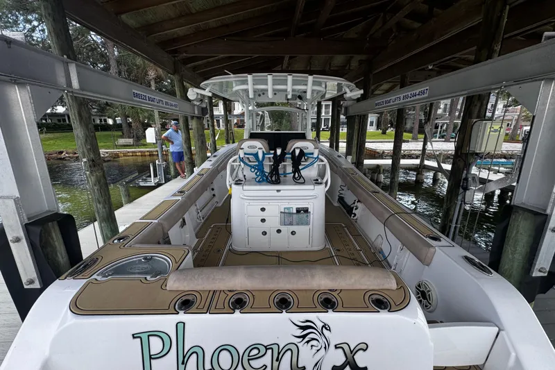 Slide: The Image of 2020 Sportsman Open 312 Center Console boat docked under a covered lift. - 13