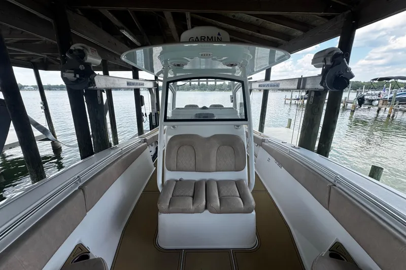 Slide: The Image of 2020 Sportsman Open 312 Center Console boat docked under a wooden structure. - 15