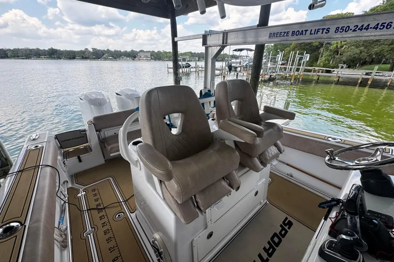 Slide: The Image of 2020 Sportsman Open 312 Center Console boat interior with dual seats and scenic lake view. - 19