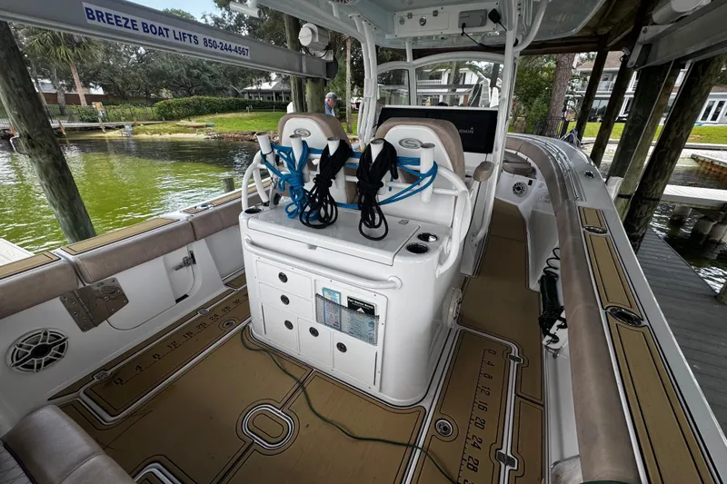 Slide: The Image of 2020 Sportsman Open 312 Center Console boat interior with fishing gear and seating. - 20