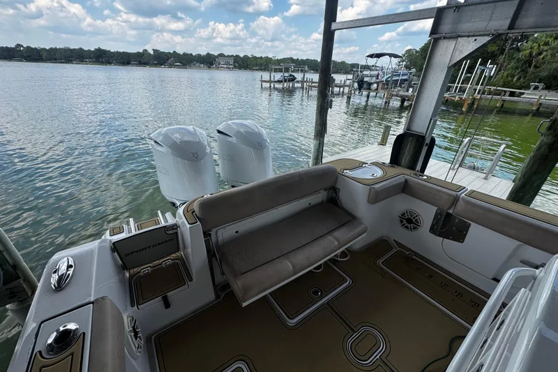 Slide: The Image of 2020 Sportsman Open 312 Center Console boat docked by a serene lake. - 22