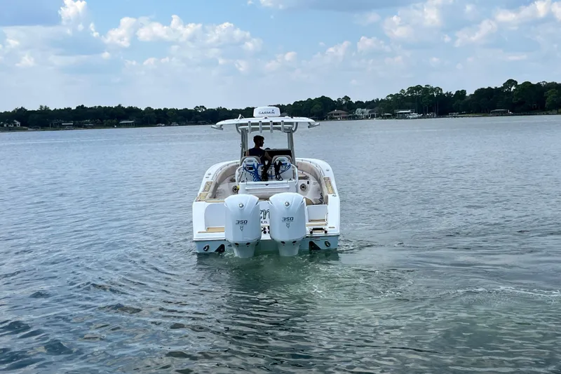 Slide: The Image of 2020 Sportsman Open 312 Center Console boat on calm water, rear view. - 4