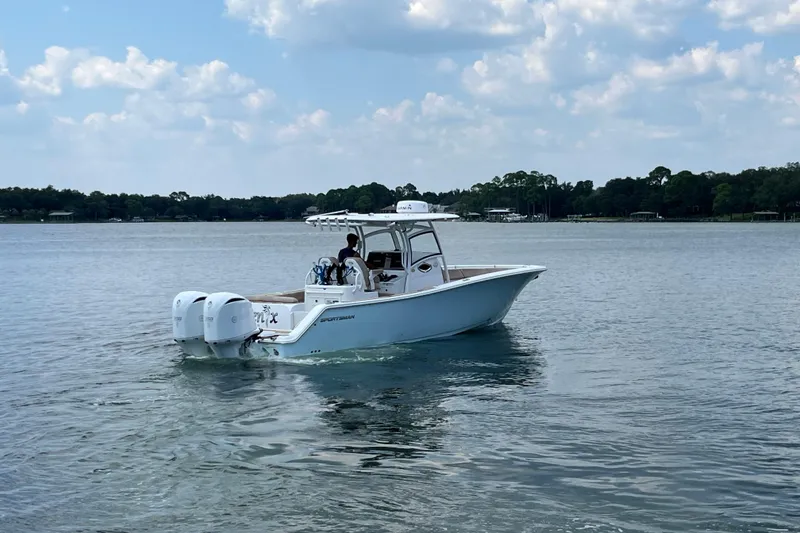 Slide: The Image of 2020 Sportsman Open 312 Center Console boat on a calm lake under a cloudy sky. - 5