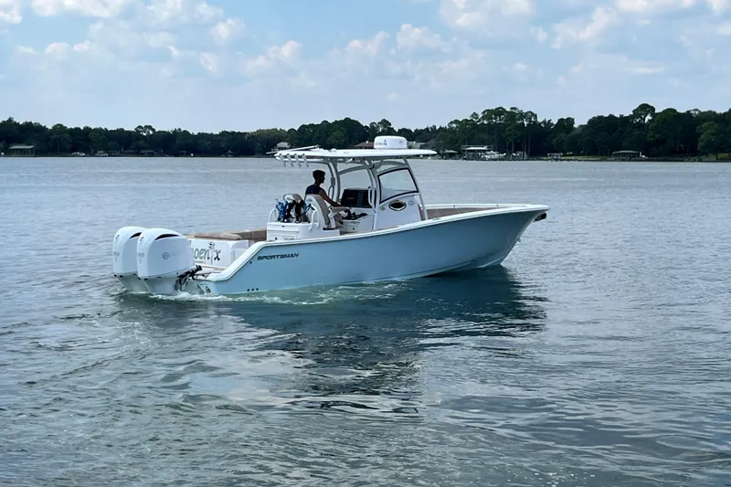 Slide: The Image of 2020 Sportsman Open 312 Center Console boat cruising on a calm lake. - 6