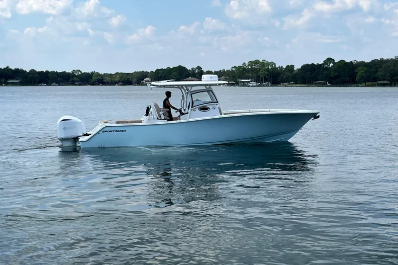 Slide: The Image of 2020 Sportsman Open 312 Center Console boat on calm lake waters. - 7