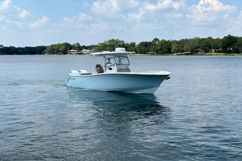 Slide: The Image of 2020 Sportsman Open 312 Center Console boat on calm water under a blue sky. - 9