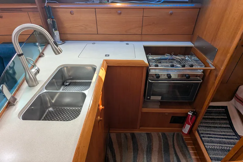 Slide: The Image of Galley kitchen in 2002 Jeanneau Sun Odyssey 37 sailboat with sink and stove. - 10