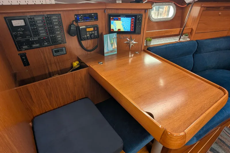Slide: The Image of Cozy interior of 2002 Jeanneau Sun Odyssey 37 sailboat with navigation equipment. - 11