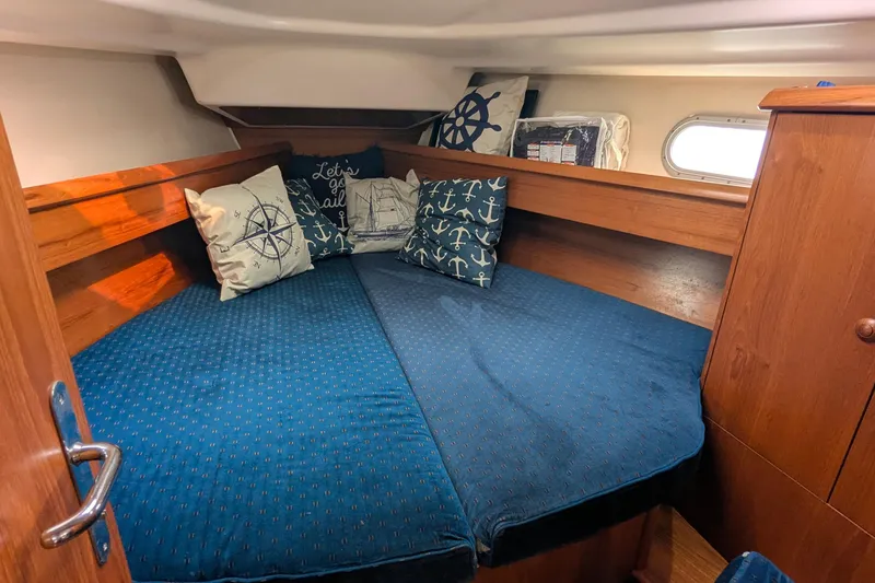 Slide: The Image of Cozy cabin interior of 2002 Jeanneau Sun Odyssey 37 with nautical-themed pillows. - 14