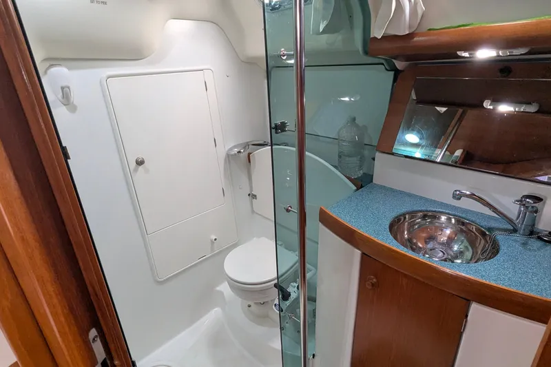 Slide: The Image of Bathroom interior of 2002 Jeanneau Sun Odyssey 37 yacht, featuring sink and toilet. - 17