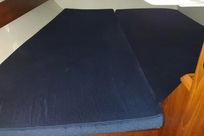 Slide: The Image of Cabin interior of 2002 Jeanneau Sun Odyssey 37 with blue cushions. - 18