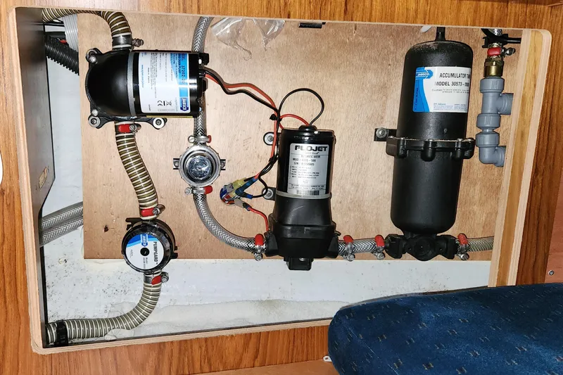 Slide: The Image of Electrical system inside a 2002 Jeanneau Sun Odyssey 37 yacht, featuring pumps and wiring. - 25